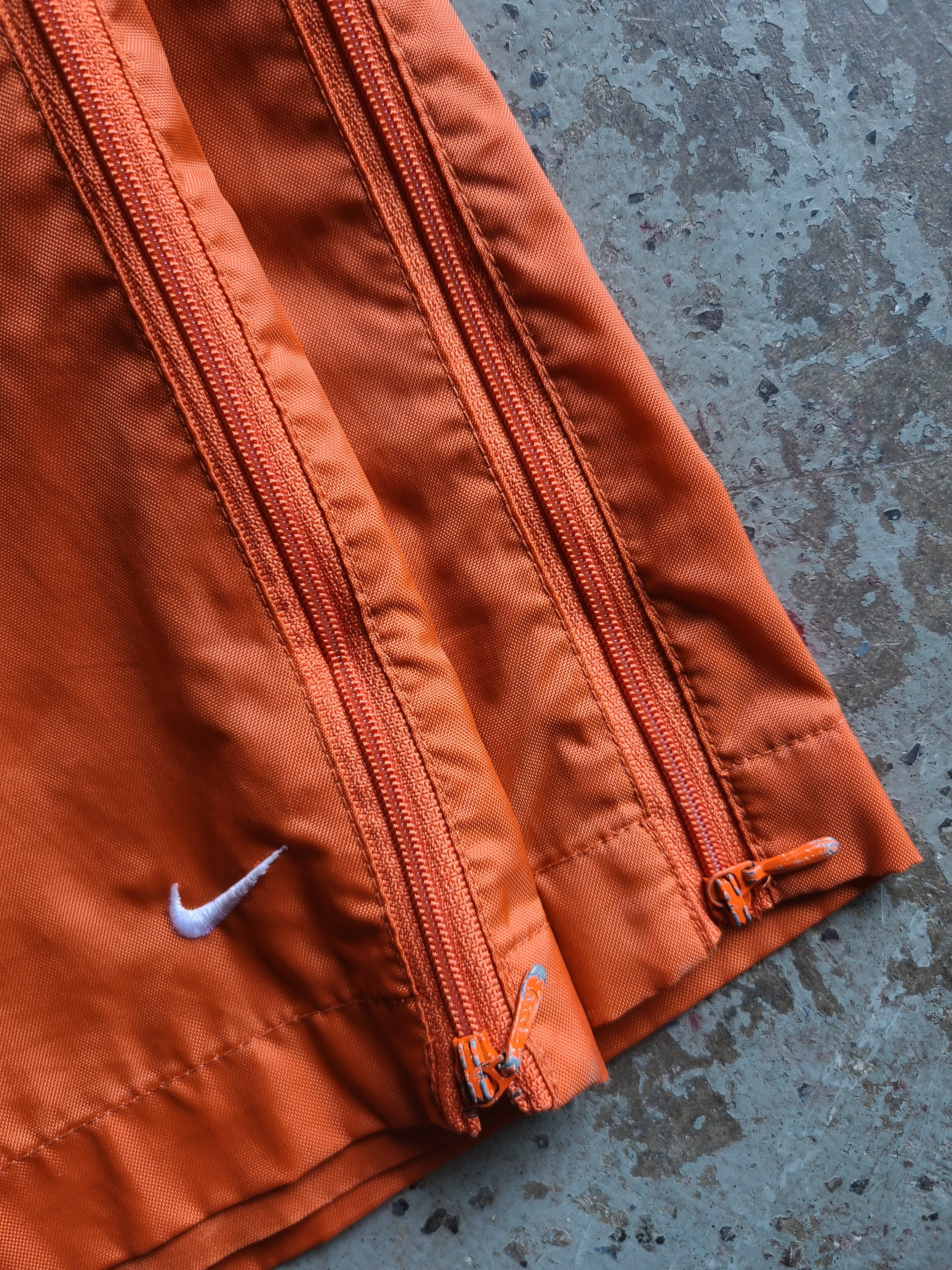 Nike track pants orange best sale